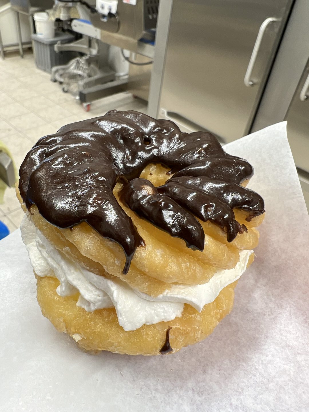 Chocolate Dipped Cruller Filled with Whip Cream Village Bake Shop